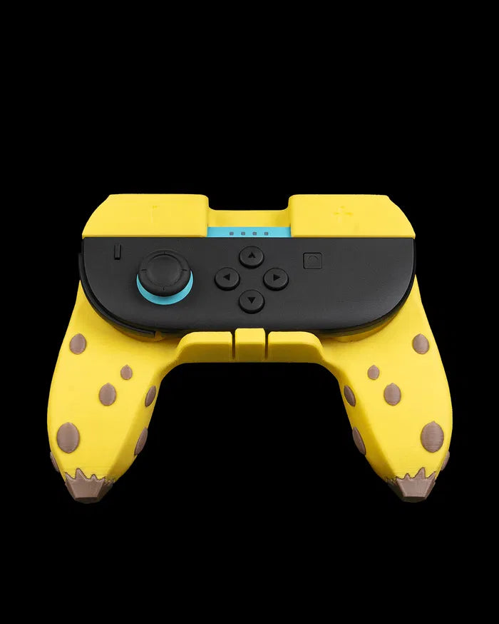 Yellow banana-themed controller grip holding a black game controller on a black background