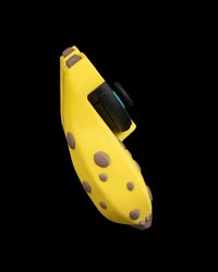 Side view of a curved yellow banana-themed controller grip with brown spots and black controls
