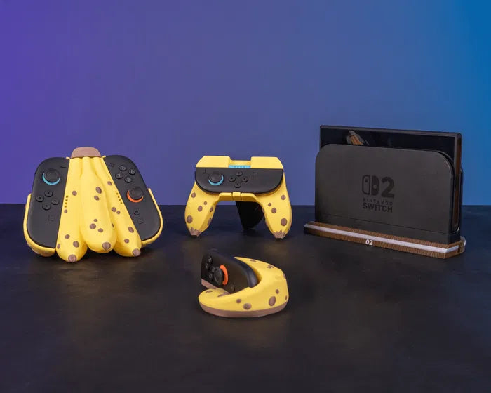 Tabletop scene with several banana-themed controller accessories and a console dock