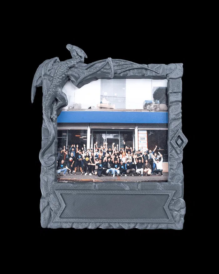 Gray dragon-themed photo frame holding a horizontal group photo on a black background