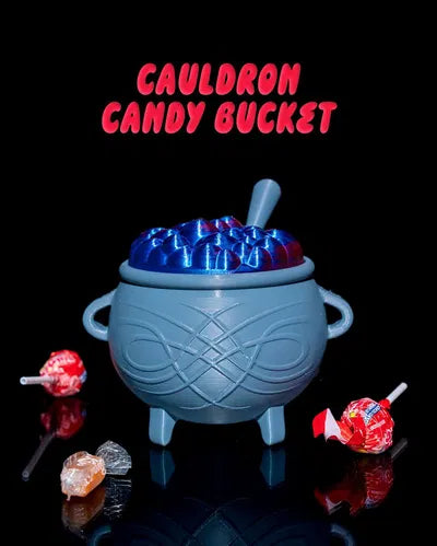 Halloween-themed cauldron candy bucket with blue candy and surrounding lollipops on a black background