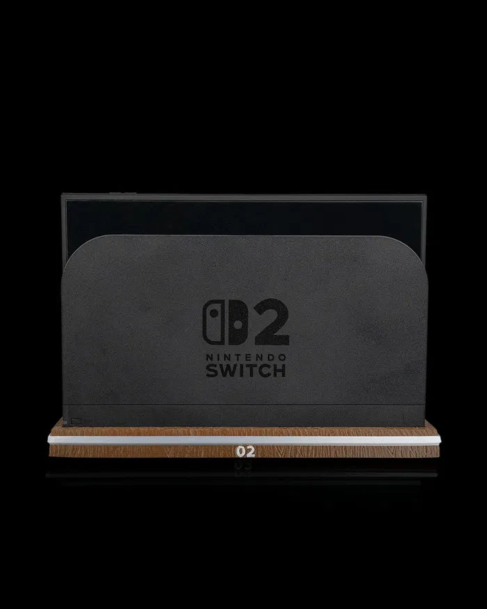 Front view of a black console dock seated on a wood-tone base with a light stripe and 02 marking