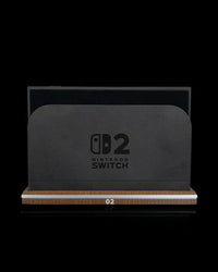 Front view of a black console dock seated on a wood-tone base with a light stripe and 02 marking