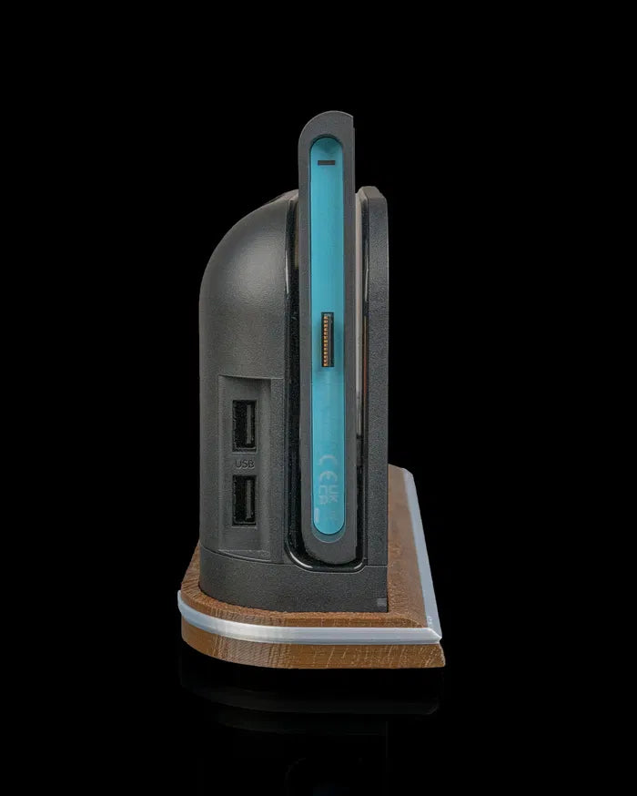Side view of a console dock on a wood-tone base with a blue controller edge visible