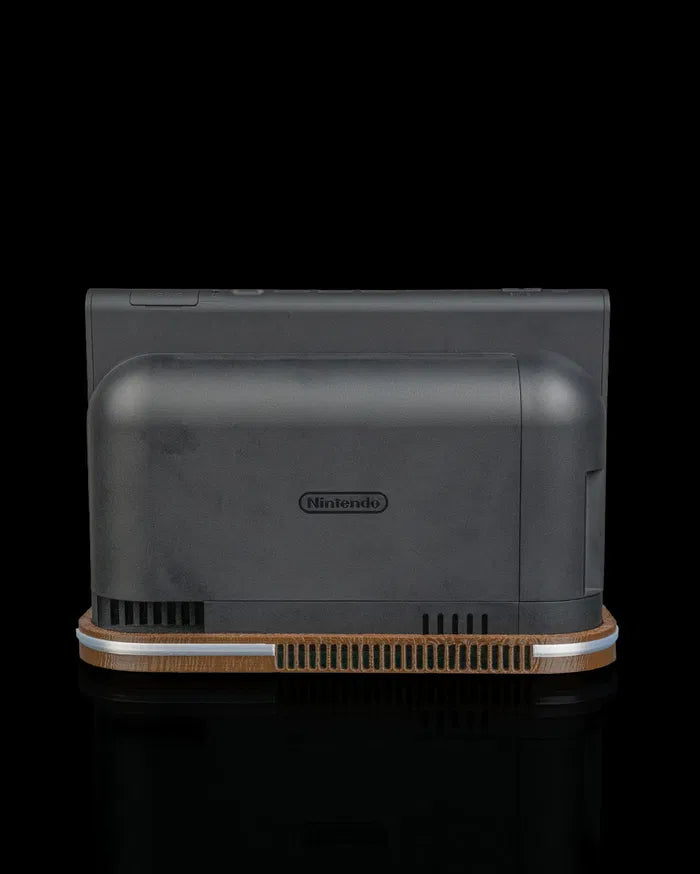 Rear view of a black console dock on a wood-tone base with vent openings