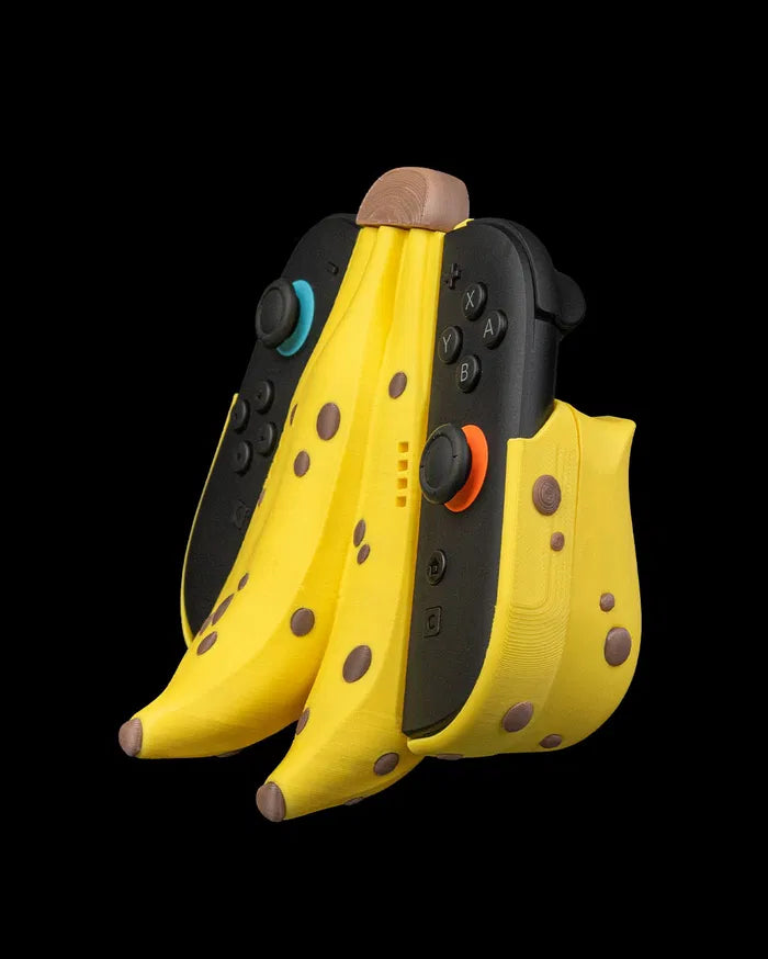 Angled view of a yellow banana bunch controller grip with black controls and brown spot details