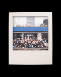 White instant-style photo frame holding a group photo on a black background