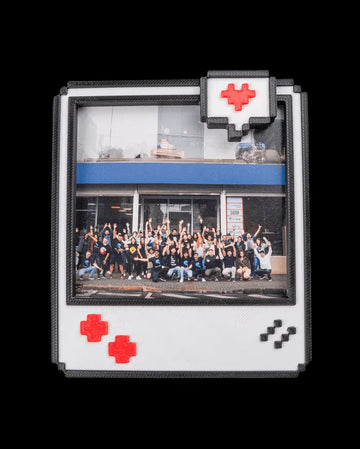 Pixel-style photo frame with black border, white face, red accents, and a group photo inside