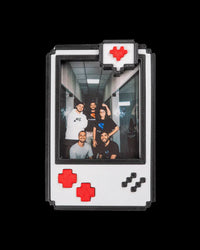 Pixel-style photo frame with black border, white face, red accents, and a portrait photo inside