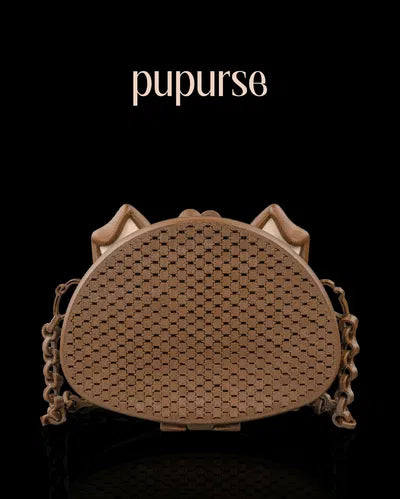 Brown 3D printed purse shaped like a dog face with ears and a mesh texture, finished with a matching chain strap.