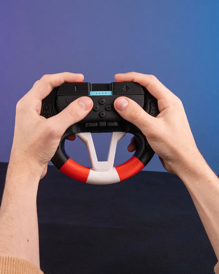 Hands holding a black, white, and orange steering wheel grip with a controller