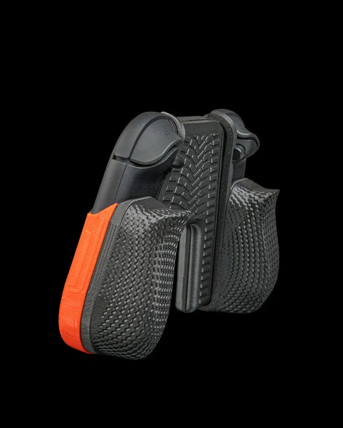Angled rear view of a black controller grip with textured handles and orange accent