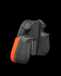 Angled rear view of a black controller grip with textured handles and orange accent