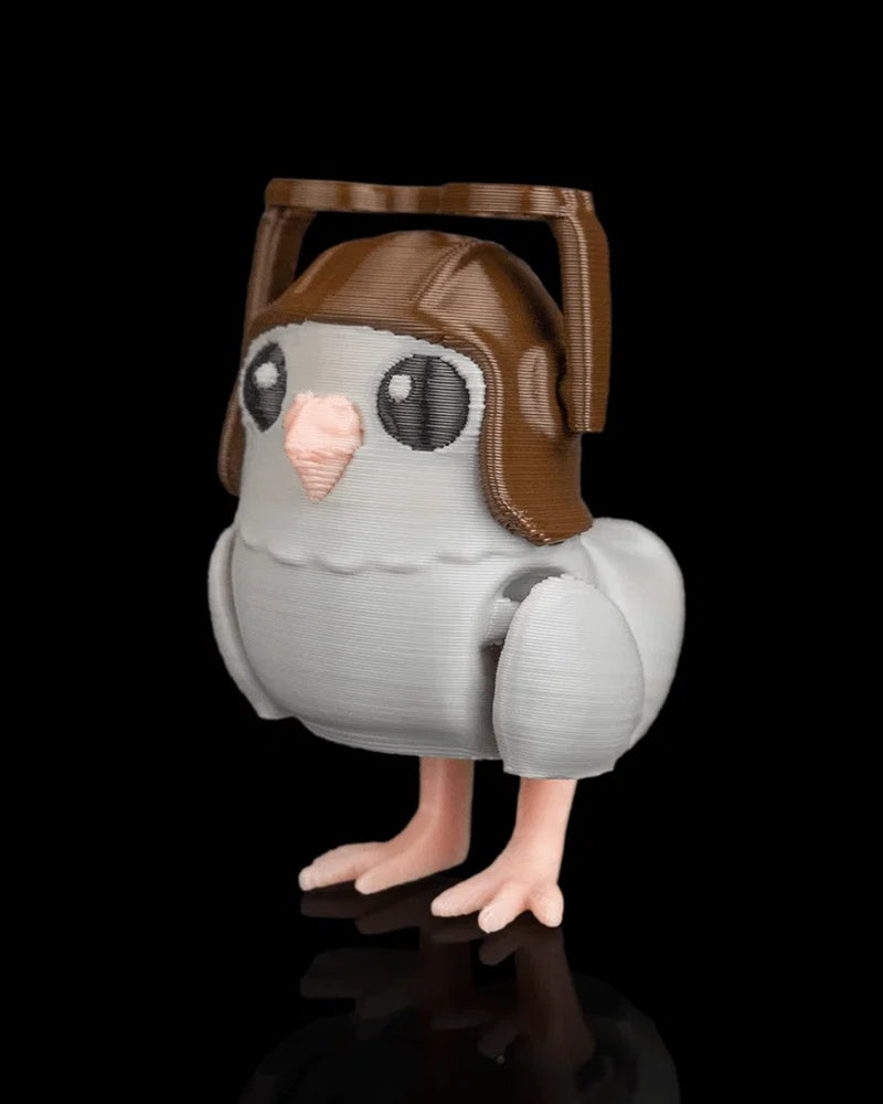 Small gray pigeon figurine shown from an angled front view with brown helmet