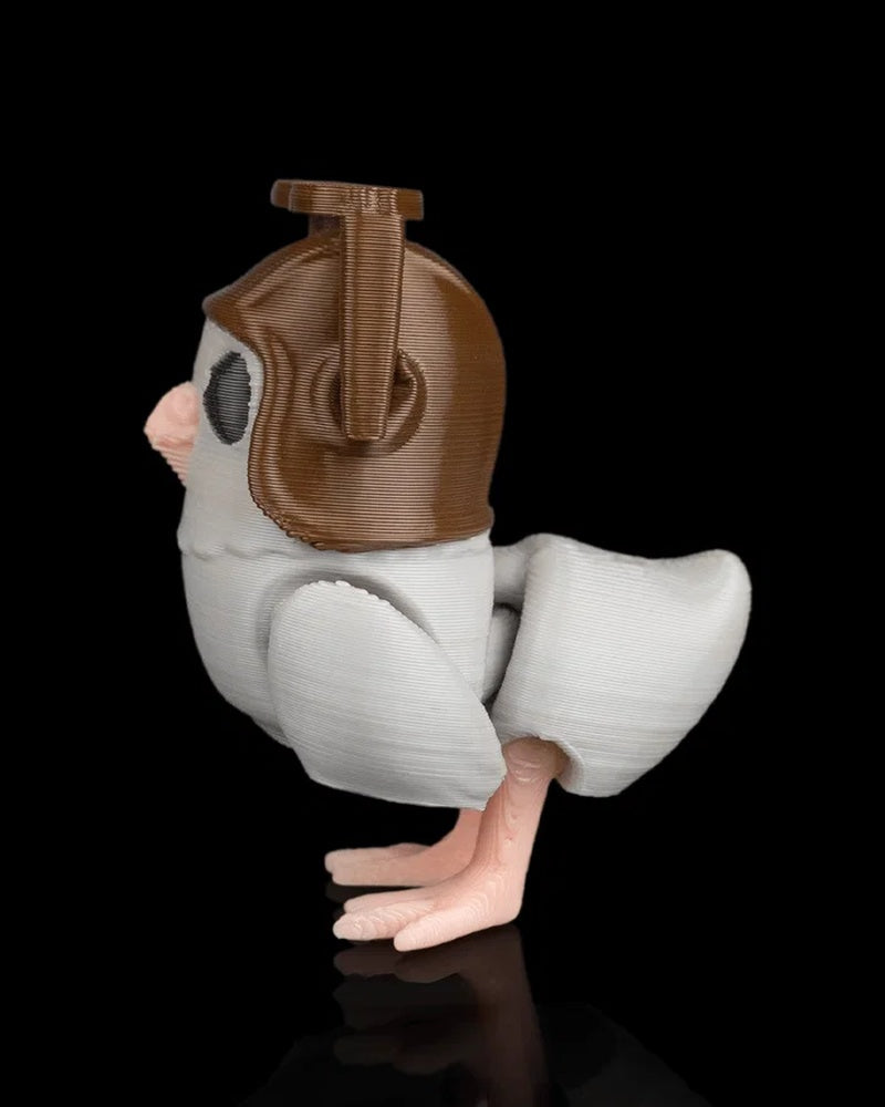 Side view of a small gray pigeon figurine with brown helmet, wing, tail, and pink feet