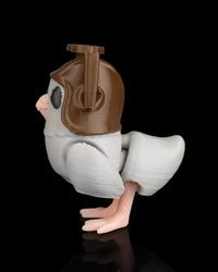 Side view of a small gray pigeon figurine with brown helmet, wing, tail, and pink feet