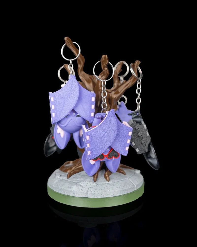 Tree display stand holding several purple and gray hanging bat figures with metal rings
