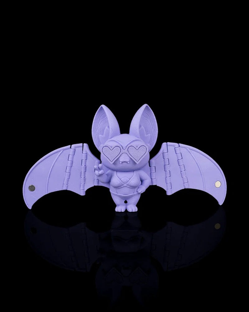 Purple bat figurine with outstretched wings and heart-shaped glasses on a black background