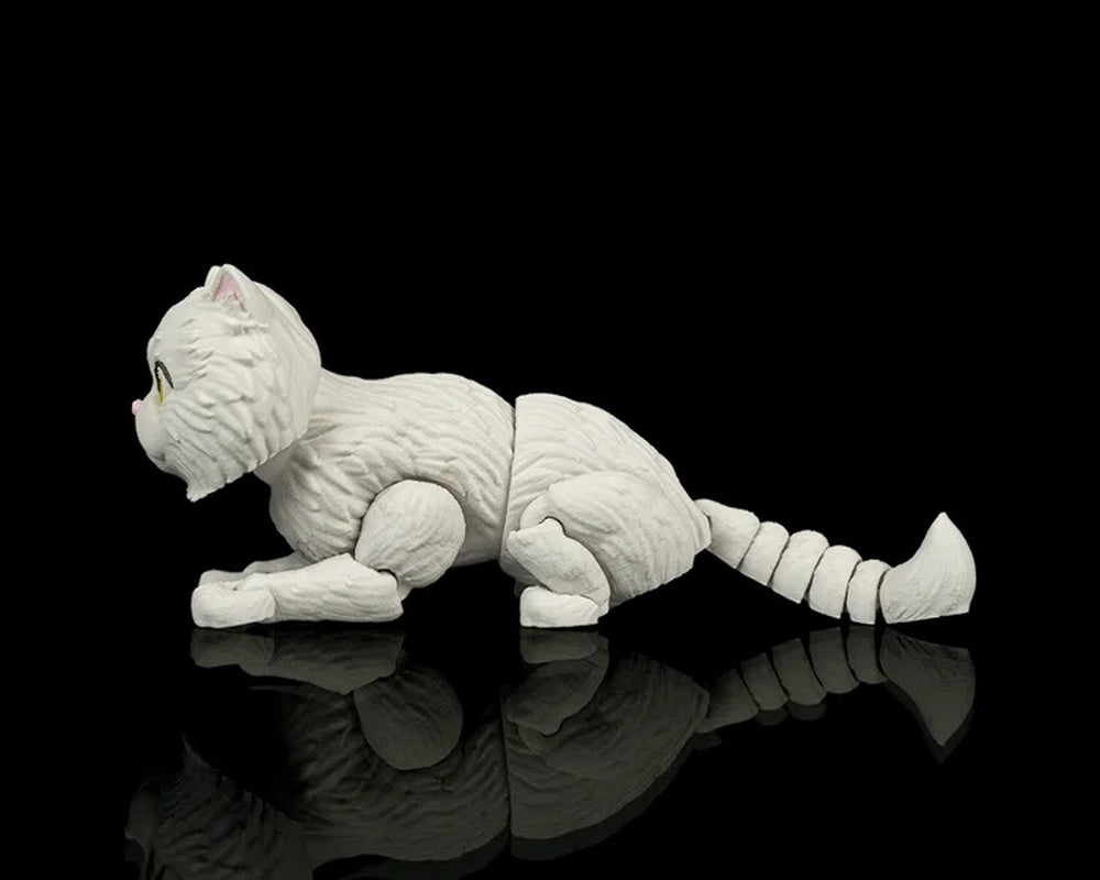 Side view of a low crouching white cat figurine with a raised tail on a black reflective surface