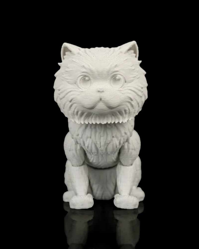 Front view of an all-white cat figurine with molded eyes, upright ears, and textured fur on a black reflective surface