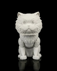 Front view of an all-white cat figurine with molded eyes, upright ears, and textured fur on a black reflective surface