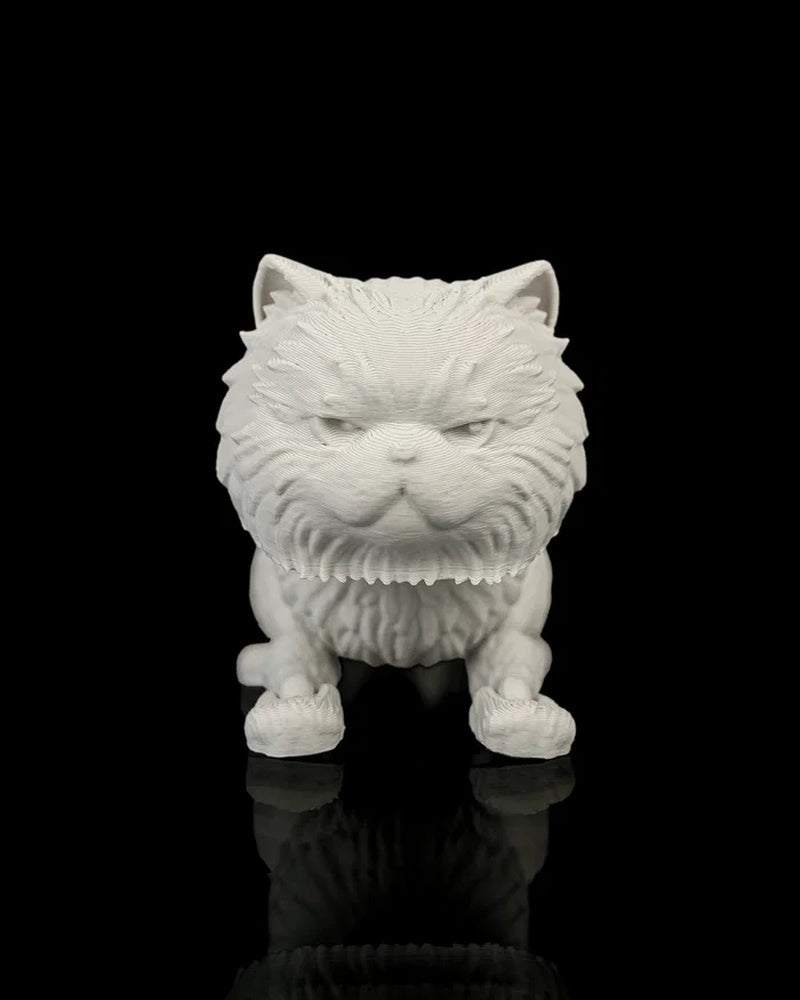 Front view of an all-white crouching cat figurine with narrowed molded eyes on a black reflective surface