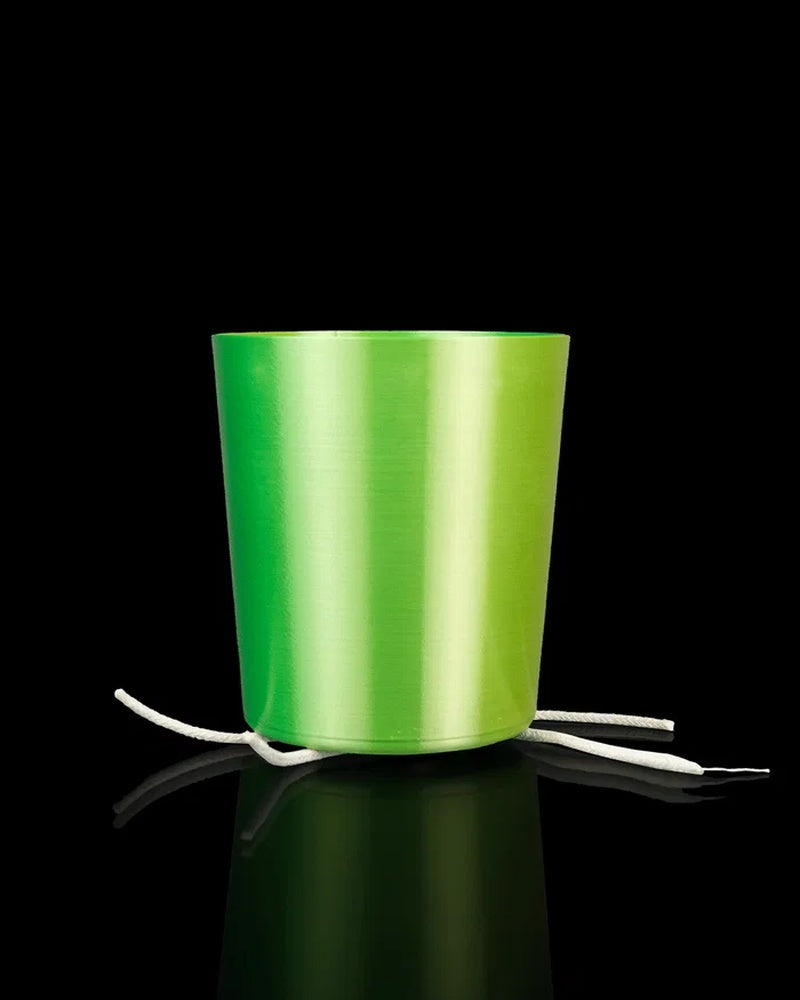 Green inner plant pot with white cords on a black background