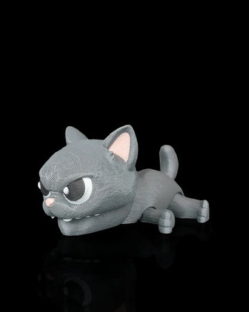 Gray cat snap toy with large eyes, pink nose, raised ears, and curled tail on a black surface