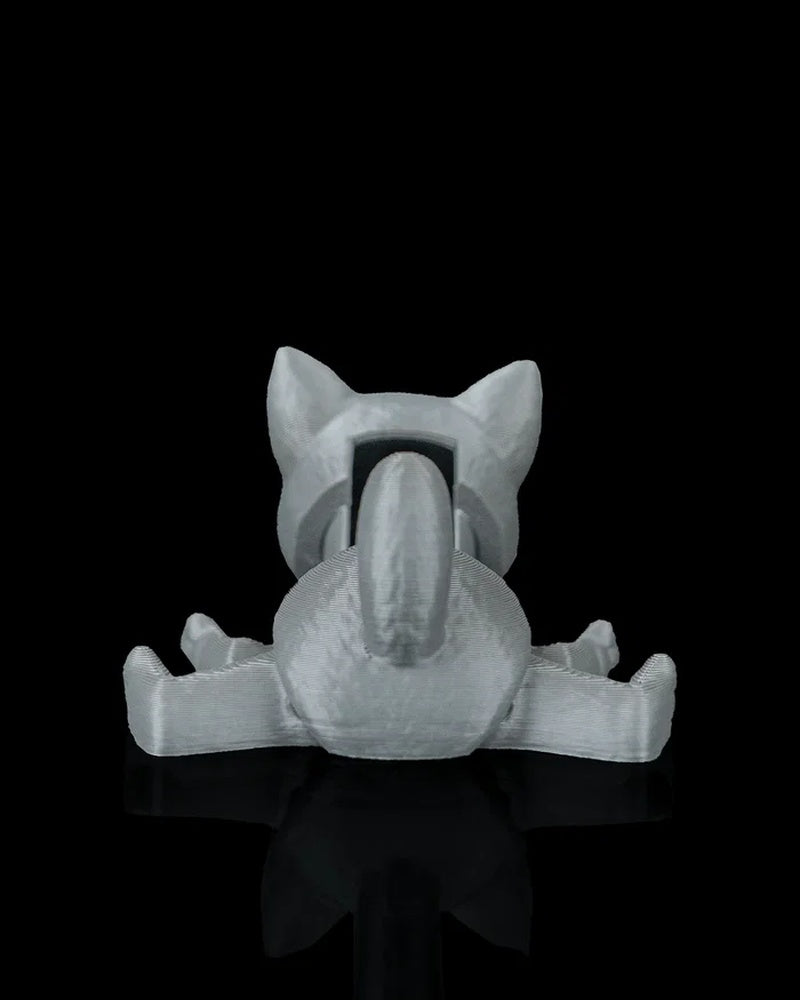 Rear view of a gray cat toy with raised tail, spread legs, and upright ears on a black surface