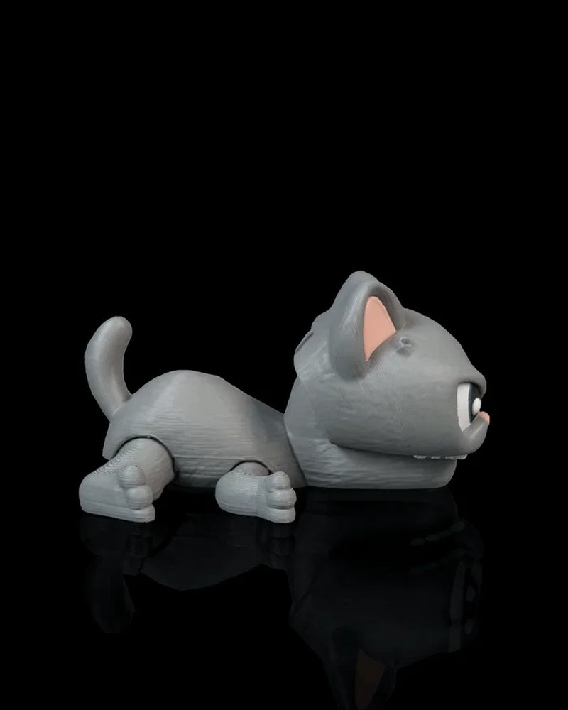 Side view of a gray cat toy with pink inner ear, curled tail, and open mouth on a black surface