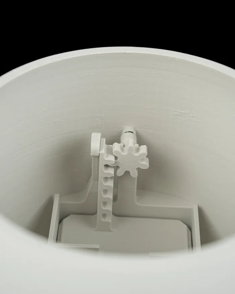 Close-up view inside a white planter showing interior supports and a small decorative shape