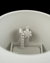 Close-up view inside a white planter showing interior supports and a small decorative shape