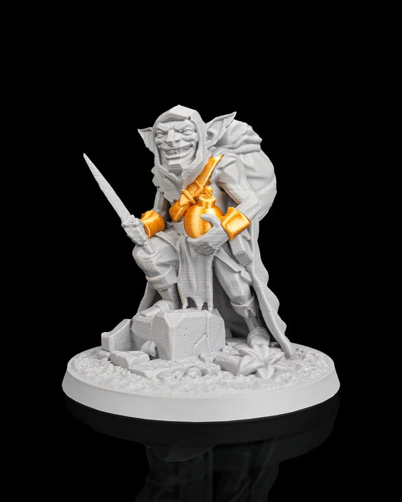 Front angled view of a gray goblin figurine with orange bomb accents, a blade, and rubble details on a round base