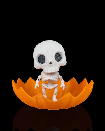 White skeleton figure sitting inside an orange jagged pumpkin shell on a black background