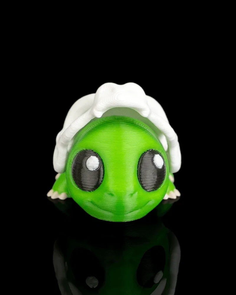 Front view of a green dinosaur figurine with large dark eyes and a white skull detail