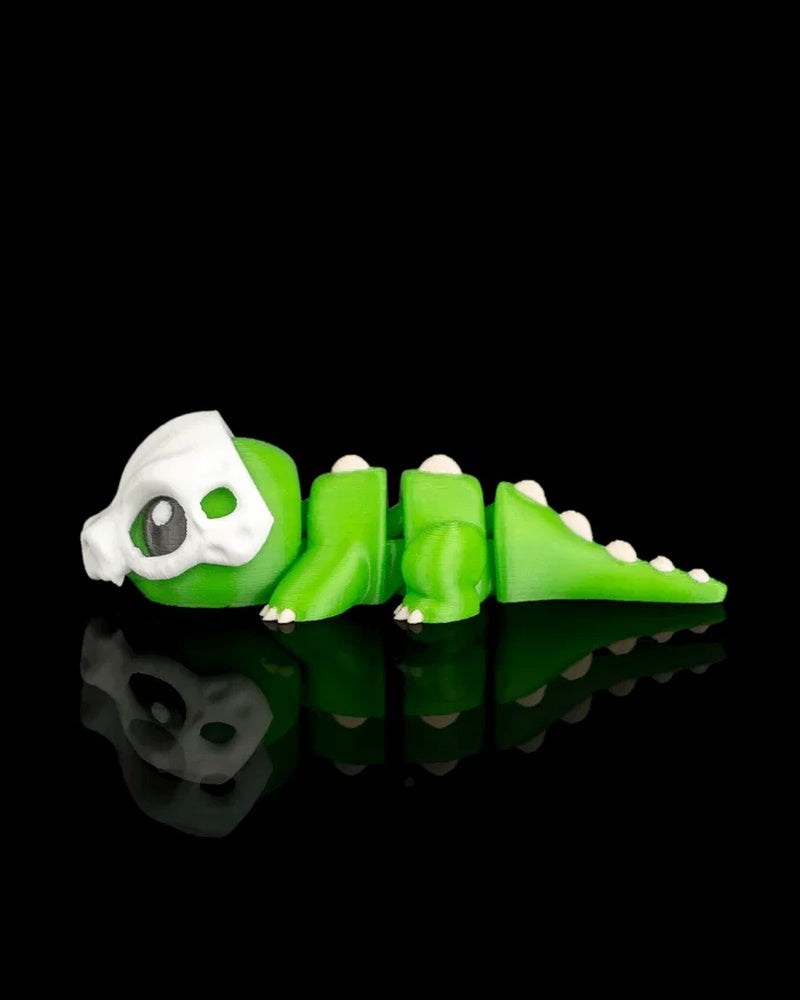 Side view of a green dinosaur figurine with a white skull detail and tail spikes