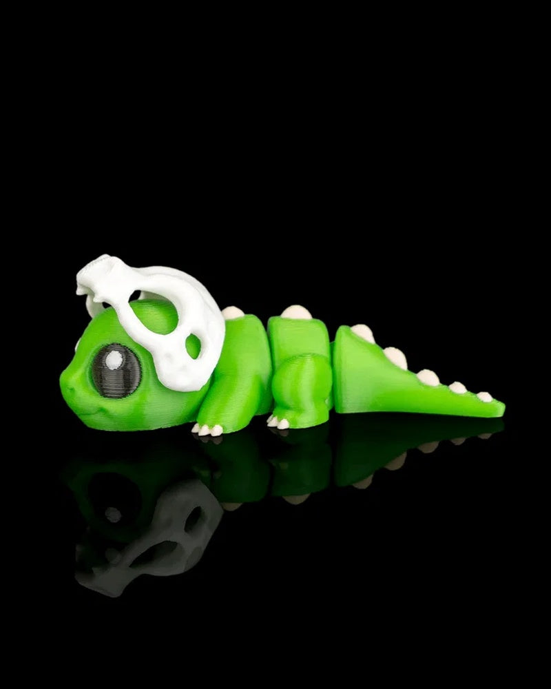Green dinosaur figurine in profile with a white skull detail over the head