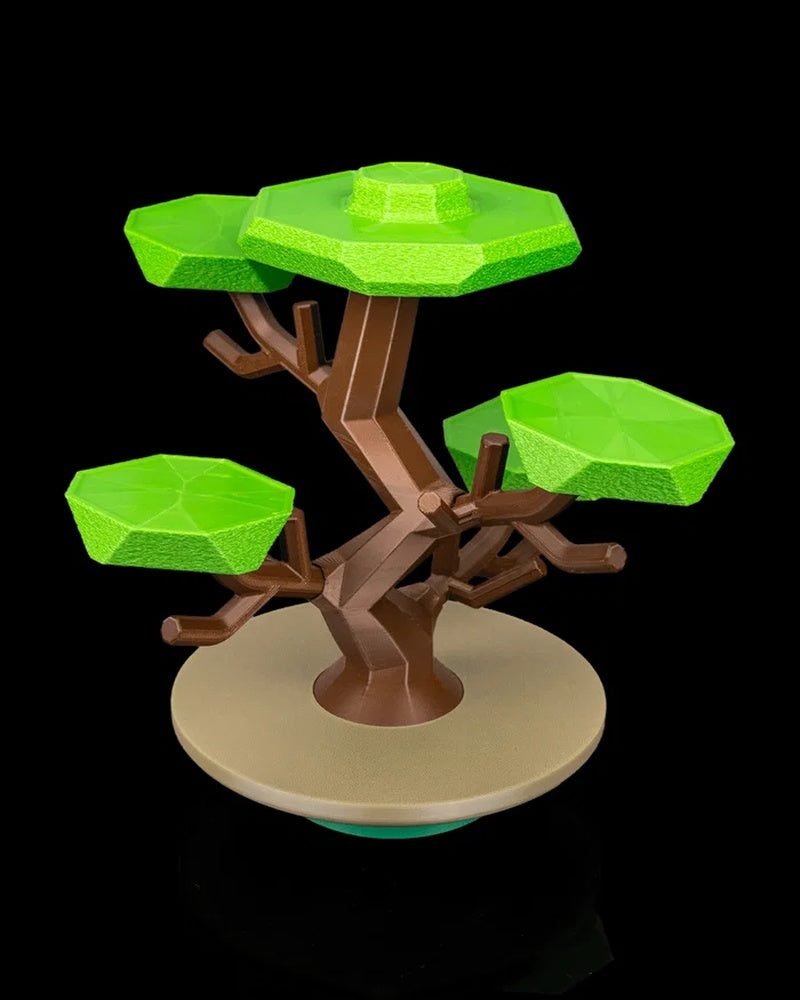 Stylized tree figurine with brown branches, bright green canopies, and a round beige base on a black background