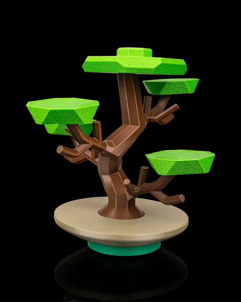 Side view of a stylized tree figurine with green layered canopies, brown branches, and a round base