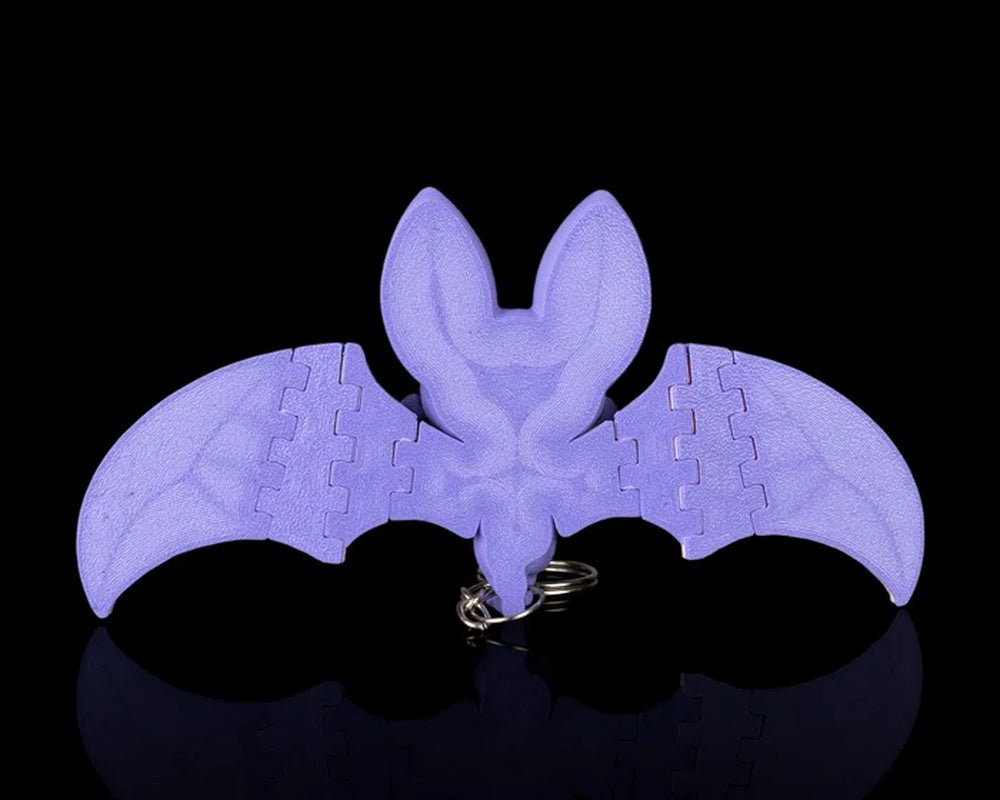 Back view of a purple bat with spread wings and a metal ring near the bottom