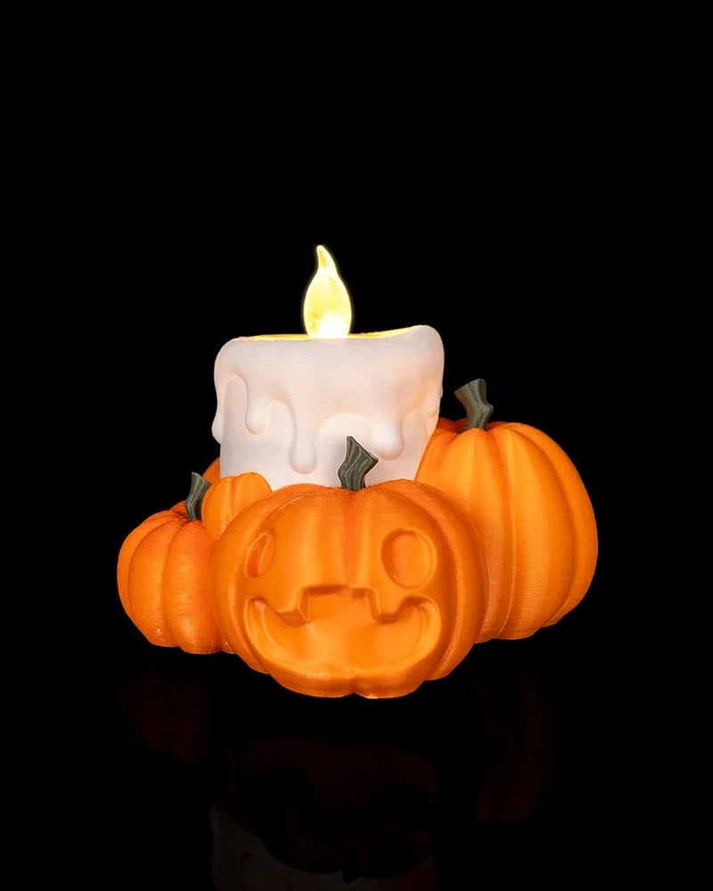 Orange pumpkin table lamp with a smiling pumpkin face and white candle with glowing flame on a black background