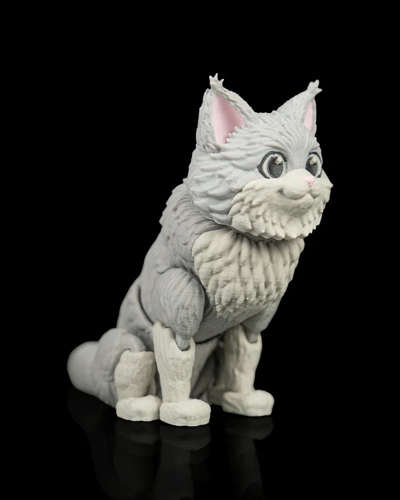Angled front view of a gray-and-white fluffy cat figurine with large eyes and a curled tail