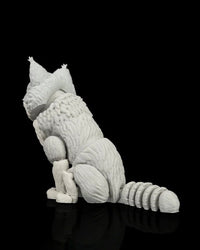 Rear angled view of a gray-and-white cat figurine showing textured fur and a curled tail