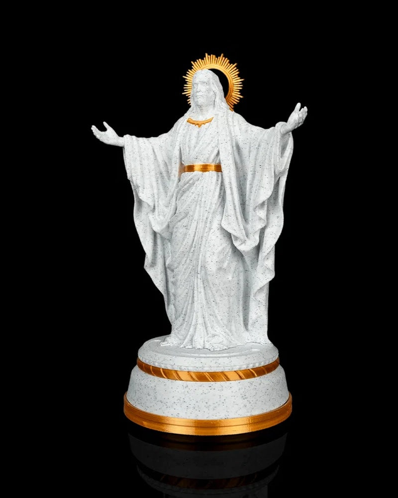 Angled front view of a white and gold Christ statue with a halo and tiered round base