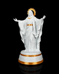 Angled front view of a white and gold Christ statue with a halo and tiered round base