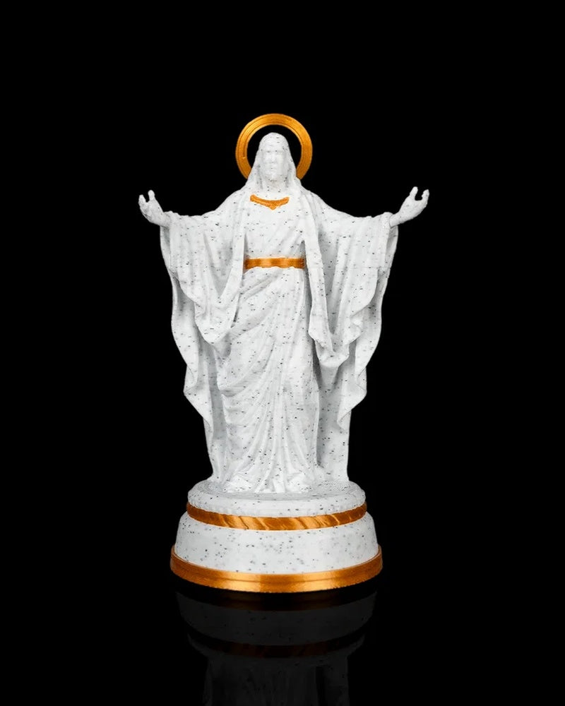 White and gold Christ statue with outstretched arms and a simple gold halo on a round base