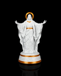 White and gold Christ statue with outstretched arms and a simple gold halo on a round base