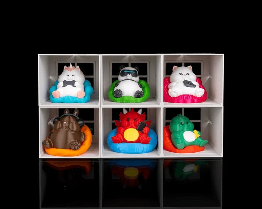 White six-cube display with colorful rounded character figures on a black background