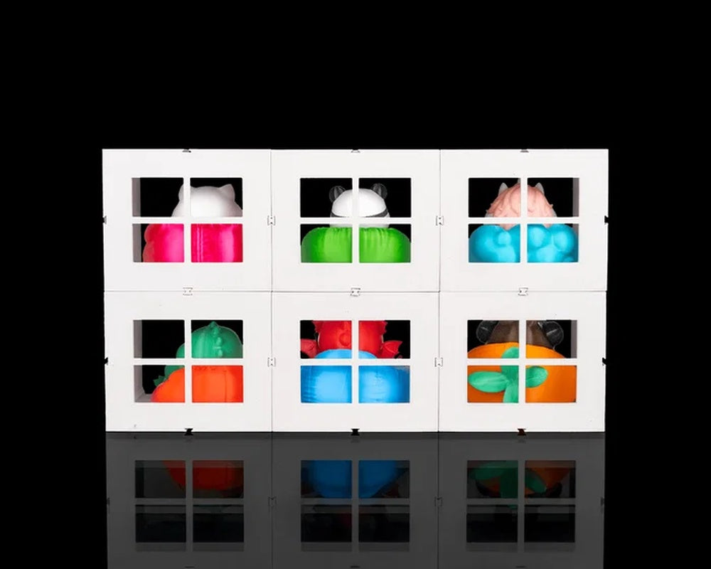Rear view of a white six-cube display with window openings and colorful figures visible inside