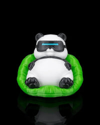 Front view of a black and white panda figurine wearing goggles while sitting in a bright green chair on a dark reflective surface.